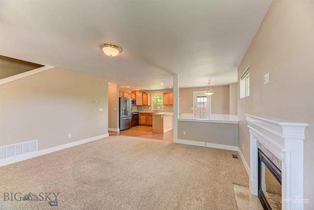 9 Sand Piper, Helena, MT 59602 - unfurnished living room with light colored carpet and a premium fireplace