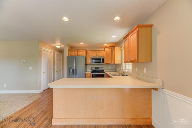 9 Sand Piper, Helena, MT 59602 - kitchen featuring appliances with stainless steel finishes, light countertops, a peninsula, light wood finished floors, and recessed lighting