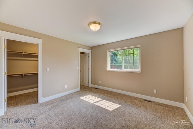 9 Sand Piper, Helena, MT 59602 - unfurnished bedroom featuring carpet, a walk in closet, and a closet