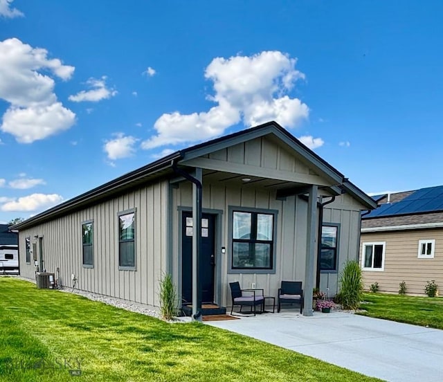 165 Johnson Ave, Dillon, MT 59725 - view of front of home with board and batten siding and a front yard