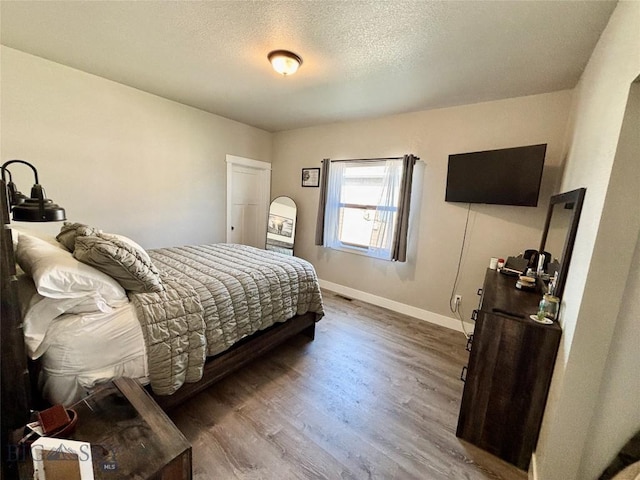 165 Johnson Ave, Dillon, MT 59725 - bedroom featuring wood finished floors and a textured ceiling