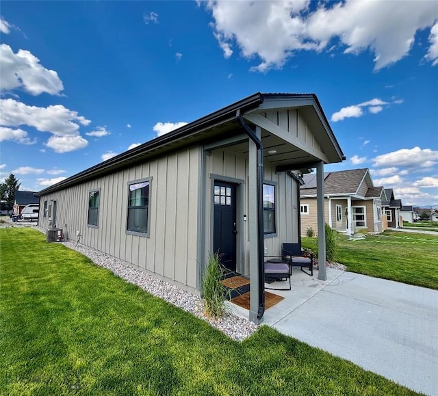 165 Johnson Ave, Dillon, MT 59725 - view of side of property featuring board and batten siding, a lawn, and a patio