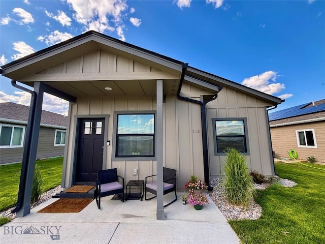 165 Johnson Ave, Dillon, MT 59725 - doorway to property with board and batten siding, a yard, and covered porch