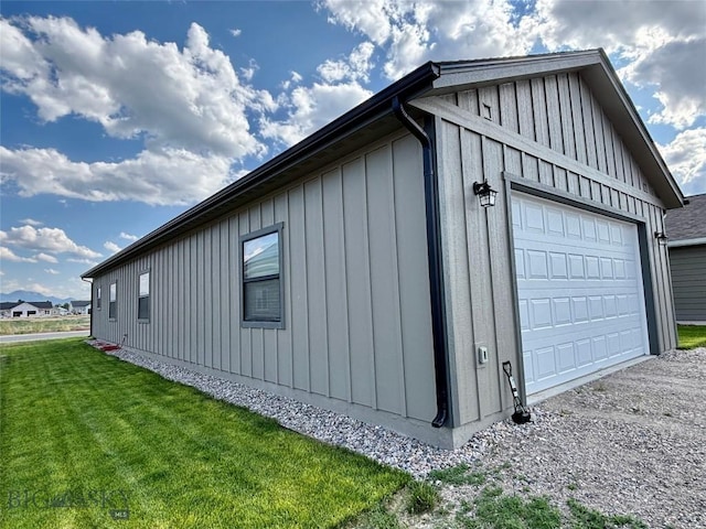 165 Johnson Ave, Dillon, MT 59725 - view of property exterior with board and batten siding, a garage, and a yard