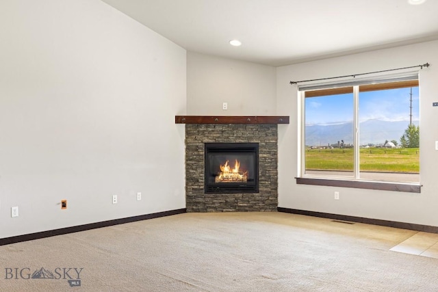 343 Stewart Loop, Bozeman, MT 59718 - unfurnished living room featuring carpet flooring, a stone fireplace, and recessed lighting