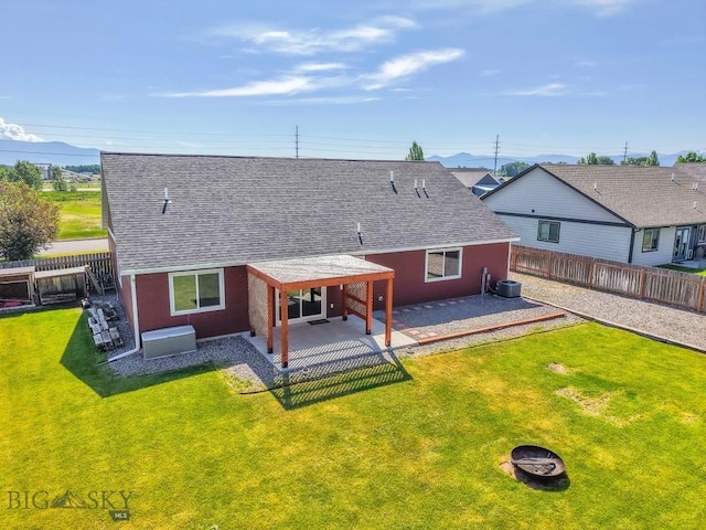 343 Stewart Loop, Bozeman, MT 59718 - rear view of property featuring a shingled roof, a patio area, and a fenced backyard