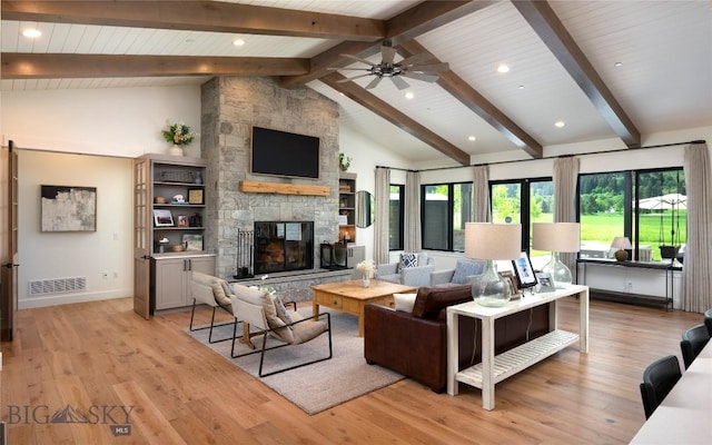 75 Vera Ct, Bozeman, MT 59718 - living room featuring beam ceiling, a fireplace, ceiling fan, light wood-type flooring, and high vaulted ceiling