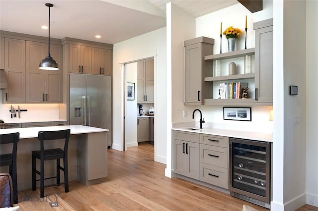 75 Vera Ct, Bozeman, MT 59718 - kitchen with wine cooler, stainless steel built in fridge, light wood-style floors, light countertops, and recessed lighting