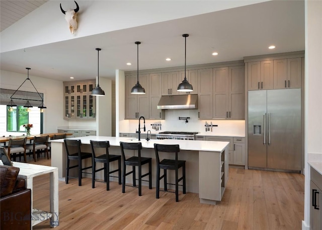 75 Vera Ct, Bozeman, MT 59718 - kitchen with stainless steel built in refrigerator, under cabinet range hood, recessed lighting, light wood finished floors, and light countertops