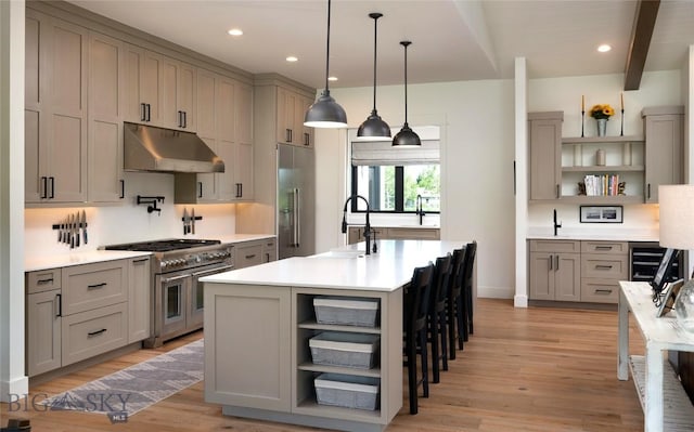 75 Vera Ct, Bozeman, MT 59718 - kitchen with open shelves, under cabinet range hood, premium appliances, gray cabinetry, and beam ceiling