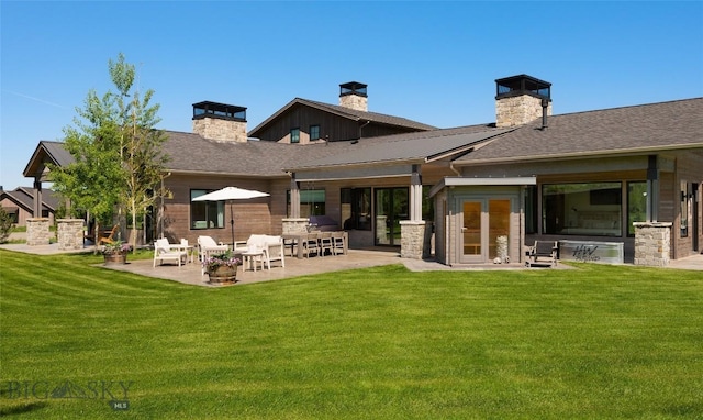 75 Vera Ct, Bozeman, MT 59718 - back of property with a patio, a chimney, a lawn, and stone siding