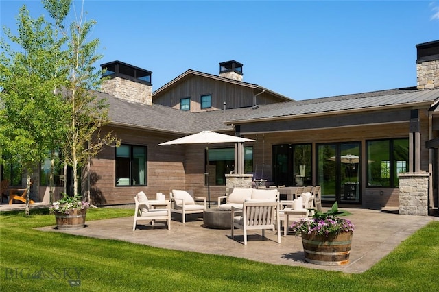75 Vera Ct, Bozeman, MT 59718 - rear view of house with a chimney, a patio, an outdoor hangout area, and a yard