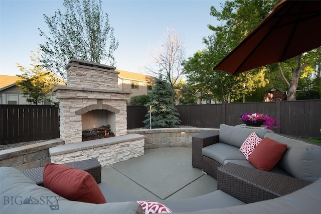 3214 Hillcrest Dr, Bozeman, MT 59715 - fenced backyard featuring a patio area and an outdoor living space with a fireplace