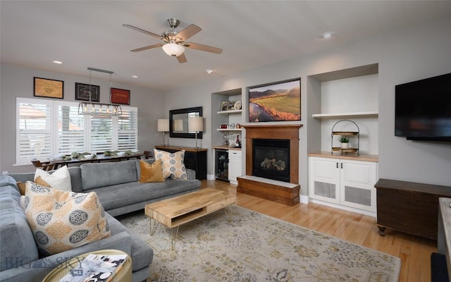 3214 Hillcrest Dr, Bozeman, MT 59715 - living room featuring a ceiling fan, wood finished floors, beverage cooler, a glass covered fireplace, and recessed lighting