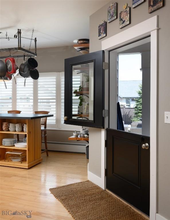 3214 Hillcrest Dr, Bozeman, MT 59715 - entryway featuring plenty of natural light, light wood-style floors, and a baseboard radiator