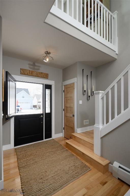 3214 Hillcrest Dr, Bozeman, MT 59715 - entrance foyer featuring a baseboard heating unit and wood finished floors