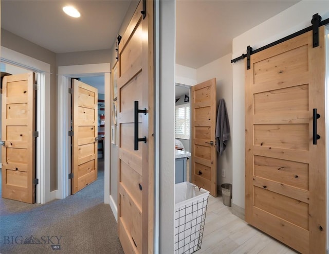 3214 Hillcrest Dr, Bozeman, MT 59715 - corridor featuring a barn door and baseboards