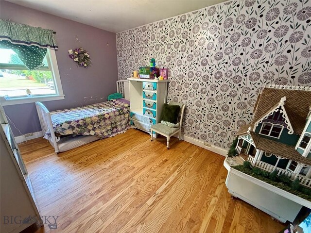 2030 Adams Ave, Butte, MT 59701 - bedroom with light wood-style floors and wallpapered walls