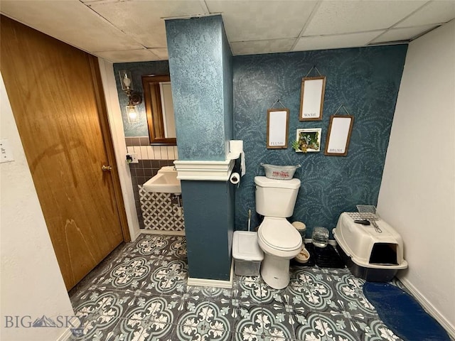 2030 Adams Ave, Butte, MT 59701 - half bath featuring a drop ceiling and tile patterned flooring