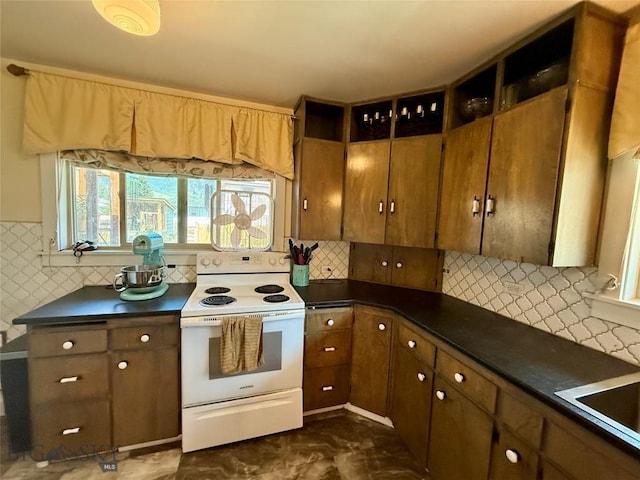 2030 Adams Ave, Butte, MT 59701 - kitchen featuring white electric stove, dark countertops, and decorative backsplash