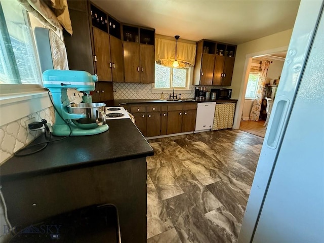 2030 Adams Ave, Butte, MT 59701 - kitchen with white appliances, dark countertops, healthy amount of natural light, and backsplash