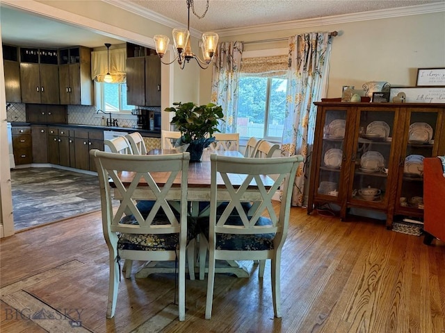 2030 Adams Ave, Butte, MT 59701 - dining area featuring crown molding, a chandelier, wood finished floors, and a textured ceiling