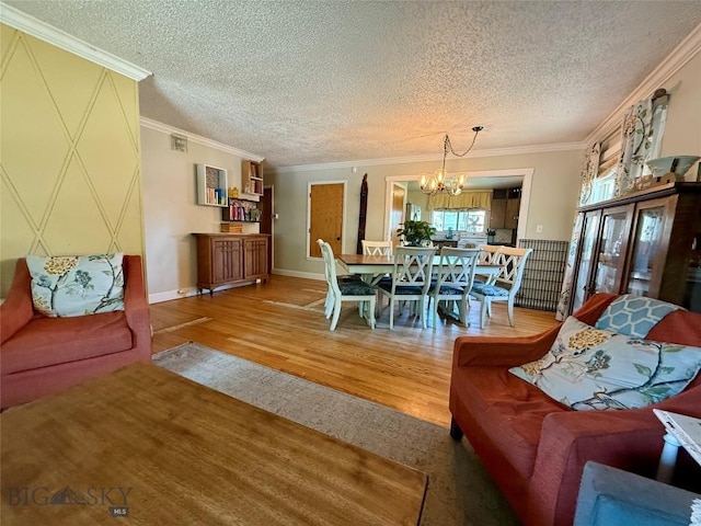 2030 Adams Ave, Butte, MT 59701 - living room featuring wood finished floors, a chandelier, a textured ceiling, and crown molding