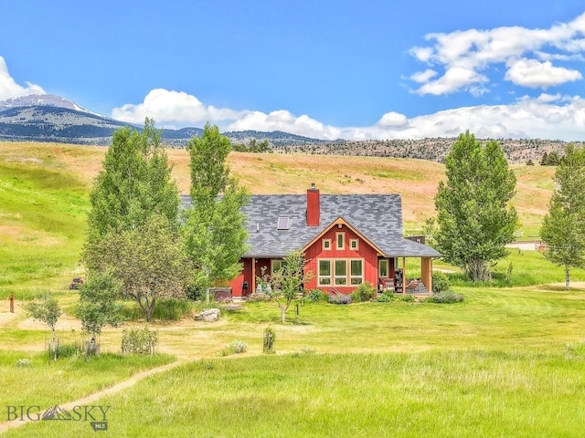 13 Blue Wing Rd, Ennis, MT 59729 - view of front of house featuring a chimney and a mountain view