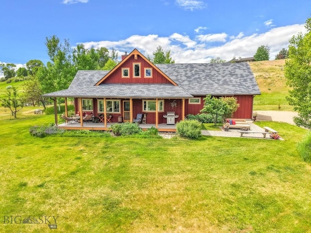 13 Blue Wing Rd, Ennis, MT 59729 - back of house with a lawn, covered porch, and a chimney