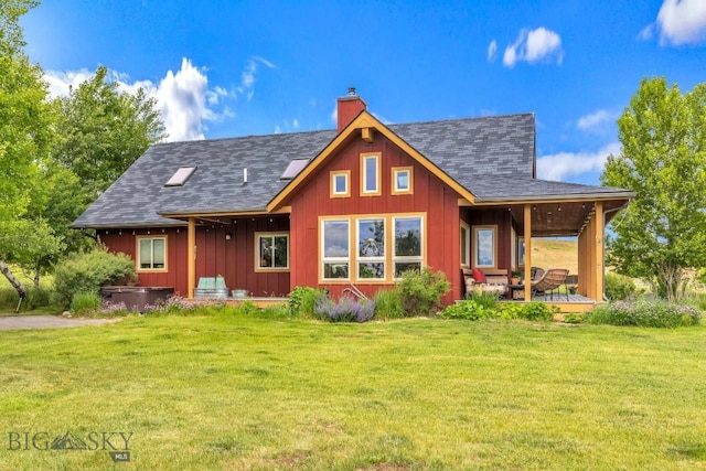 13 Blue Wing Rd, Ennis, MT 59729 - back of house with a chimney, a yard, a shingled roof, and board and batten siding
