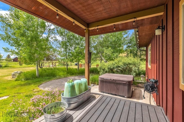 13 Blue Wing Rd, Ennis, MT 59729 - wooden terrace featuring a hot tub, a patio area, and a yard
