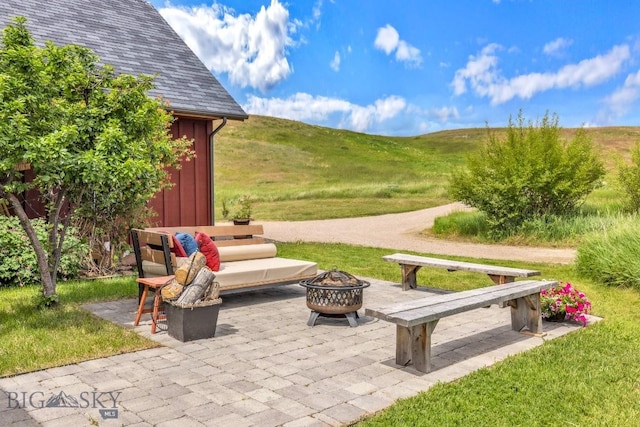 13 Blue Wing Rd, Ennis, MT 59729 - view of patio / terrace featuring an outdoor fire pit, a mountain view, and an outbuilding
