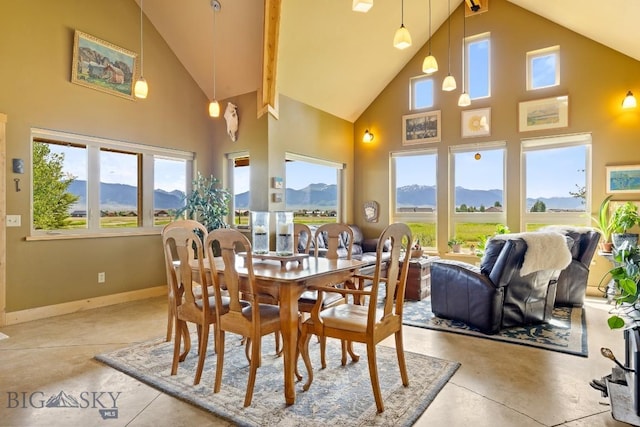 13 Blue Wing Rd, Ennis, MT 59729 - dining space with finished concrete floors, high vaulted ceiling, a mountain view, and plenty of natural light