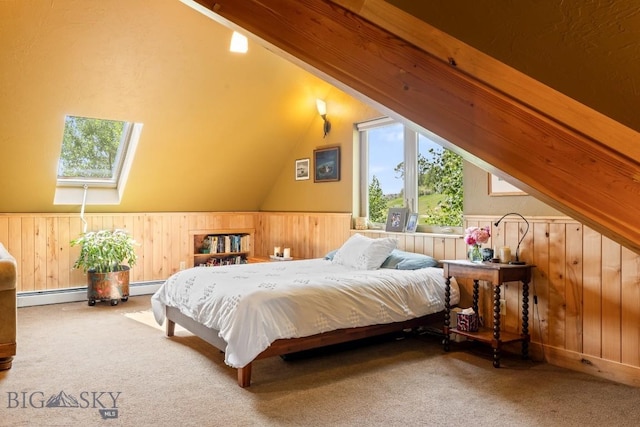 13 Blue Wing Rd, Ennis, MT 59729 - bedroom with carpet floors, wooden walls, vaulted ceiling, a baseboard radiator, and a skylight