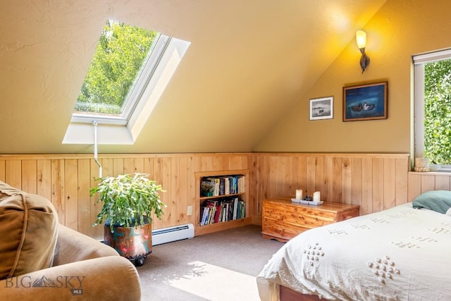 13 Blue Wing Rd, Ennis, MT 59729 - carpeted bedroom featuring baseboard heating, a skylight, wood walls, lofted ceiling, and a wainscoted wall
