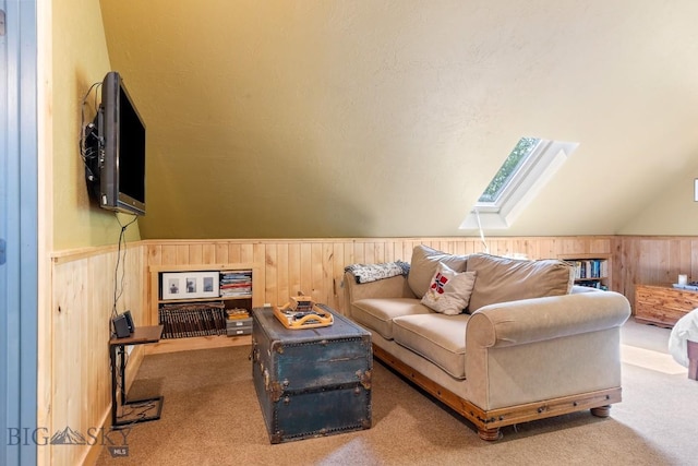 13 Blue Wing Rd, Ennis, MT 59729 - carpeted living room with a skylight, wooden walls, vaulted ceiling, and wainscoting