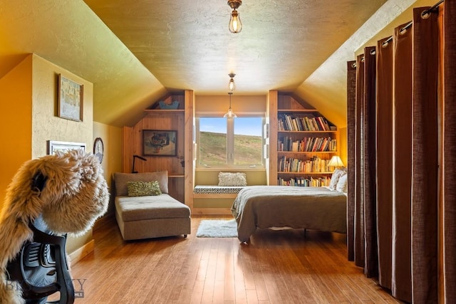 13 Blue Wing Rd, Ennis, MT 59729 - bedroom with wood-type flooring, a textured ceiling, and vaulted ceiling