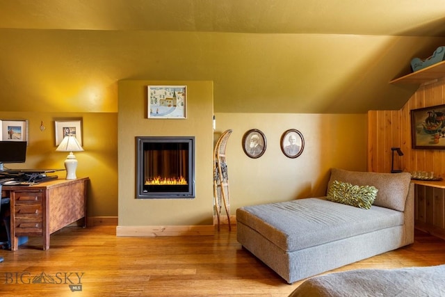13 Blue Wing Rd, Ennis, MT 59729 - bedroom featuring light wood-style floors, a glass covered fireplace, and vaulted ceiling