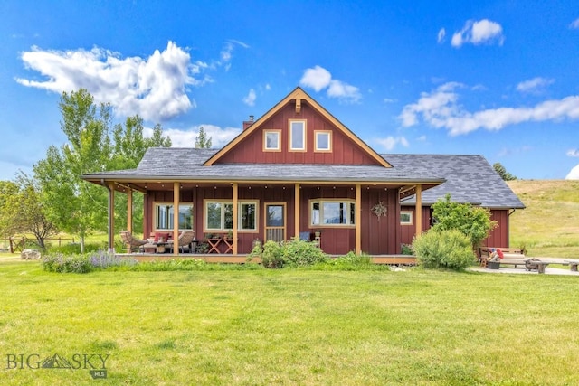 13 Blue Wing Rd, Ennis, MT 59729 - rear view of property featuring board and batten siding, a porch, and a lawn