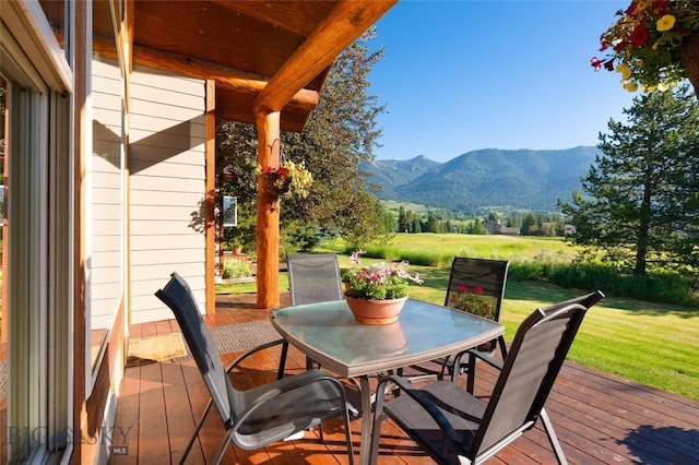 3140 Two Moons Rd, Big Sky, MT 59716 - wooden deck with a mountain view, outdoor dining space, and a yard