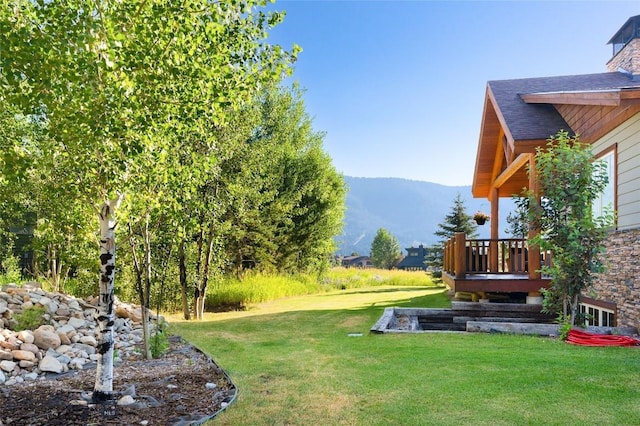 3140 Two Moons Rd, Big Sky, MT 59716 - view of grassy yard with a deck with mountain view