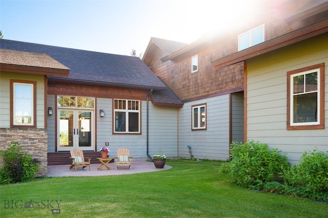 3140 Two Moons Rd, Big Sky, MT 59716 - back of house featuring french doors, a lawn, roof with shingles, and a patio area