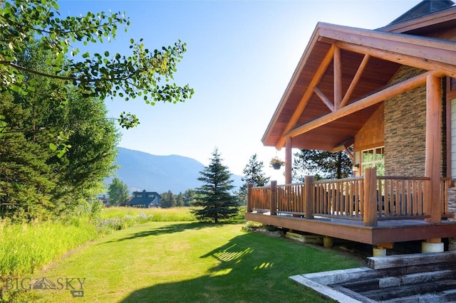 3140 Two Moons Rd, Big Sky, MT 59716 - view of green lawn with a deck with mountain view