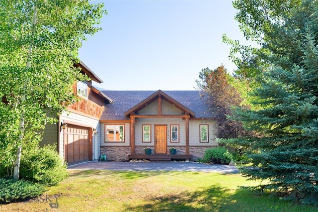 3140 Two Moons Rd, Big Sky, MT 59716 - craftsman house featuring a front lawn, stone siding, a garage, driveway, and roof with shingles