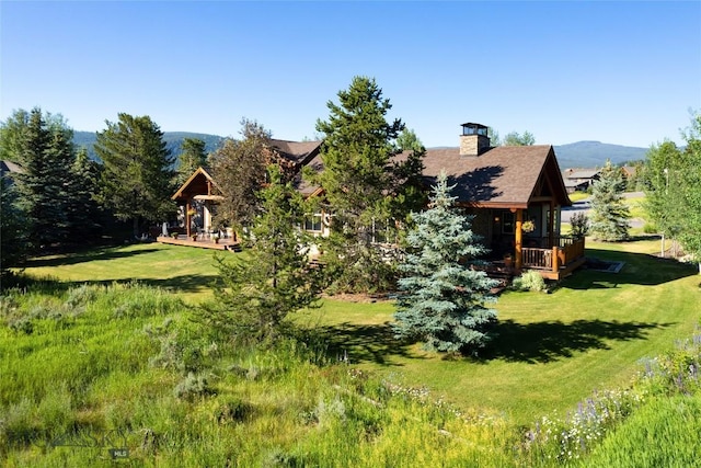 3140 Two Moons Rd, Big Sky, MT 59716 - back of house featuring a yard, a chimney, and a deck