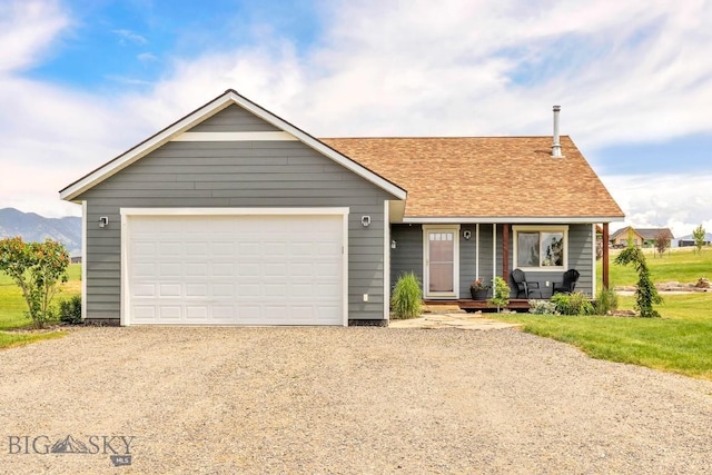 418 May Ln, Belgrade, MT 59714 - view of front facade featuring driveway, a porch, a shingled roof, and a garage