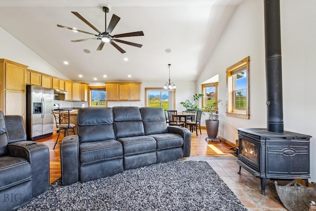 418 May Ln, Belgrade, MT 59714 - living area featuring a wood stove, ceiling fan, high vaulted ceiling, a chandelier, and recessed lighting