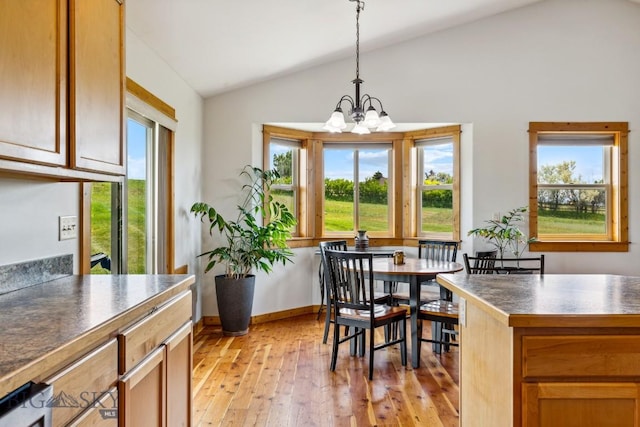 418 May Ln, Belgrade, MT 59714 - dining space featuring lofted ceiling, a chandelier, light wood-type flooring, and plenty of natural light