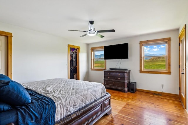 418 May Ln, Belgrade, MT 59714 - bedroom featuring hardwood / wood-style floors, a closet, a walk in closet, and a ceiling fan