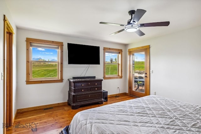 418 May Ln, Belgrade, MT 59714 - bedroom featuring access to exterior, wood finished floors, and ceiling fan